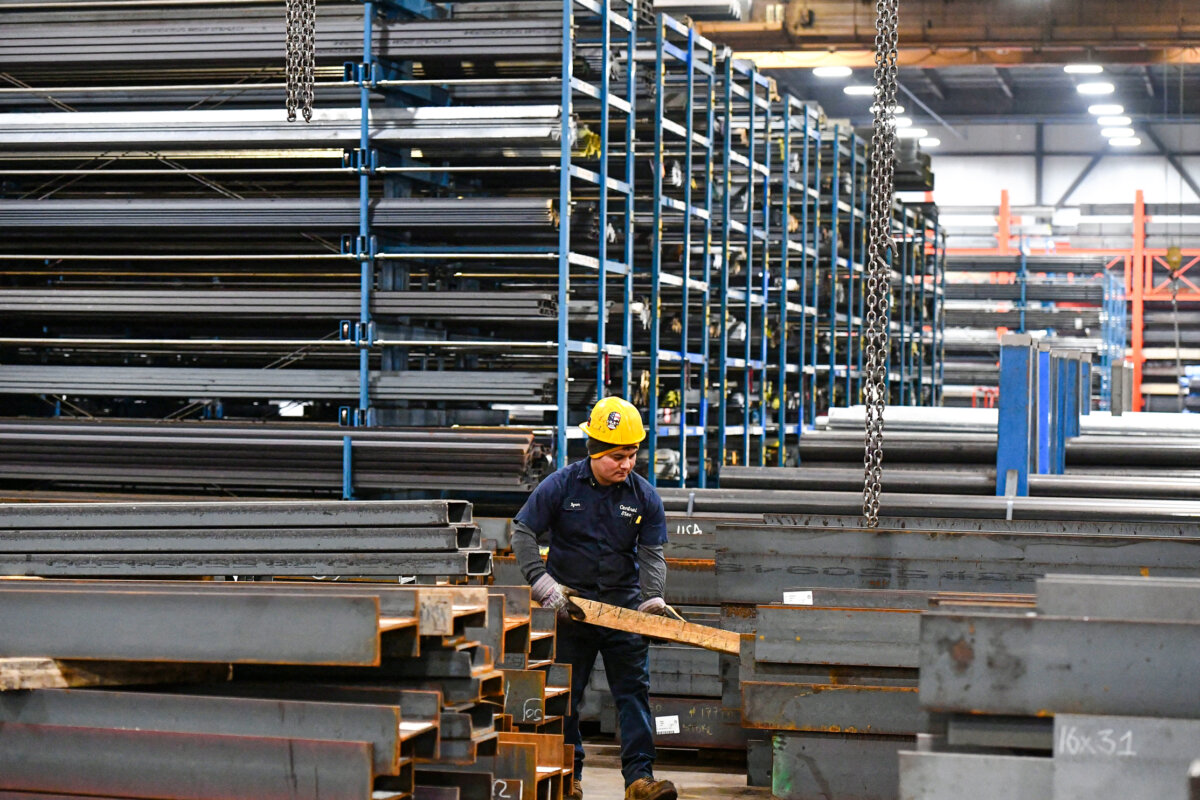 A worker prepares to lift a steel beam with a crane at Central Steel Supply Company in Marlborough, Mass., on March 13, 2025. (Joseph Prezioso/AFP via Getty Images)