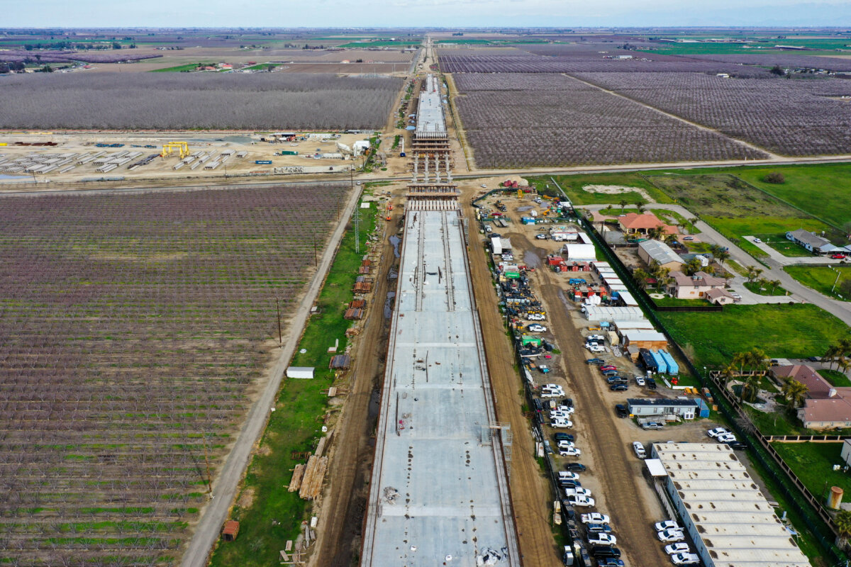 An aerial image shows construction workers building the Hanford Viaduct over Highway 198 and past agricultural fields as part of the California High Speed Rail transit project, in Hanford, Calif., on Feb. 12, 2025. (Patrick T. Fallon/AFP via Getty Images)