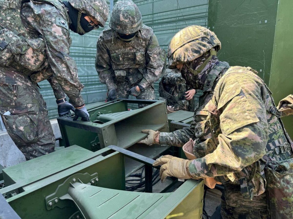 South Korean soldiers work on a loudspeaker that is set up for propaganda broadcasts during a military drill near the demilitarized zone separating the two Koreas in Paju, South Korea, in this handout picture provided by the Ministry of National Defense and released on June 9, 2024. (Ministry of National Defense/Handout via Reuters)