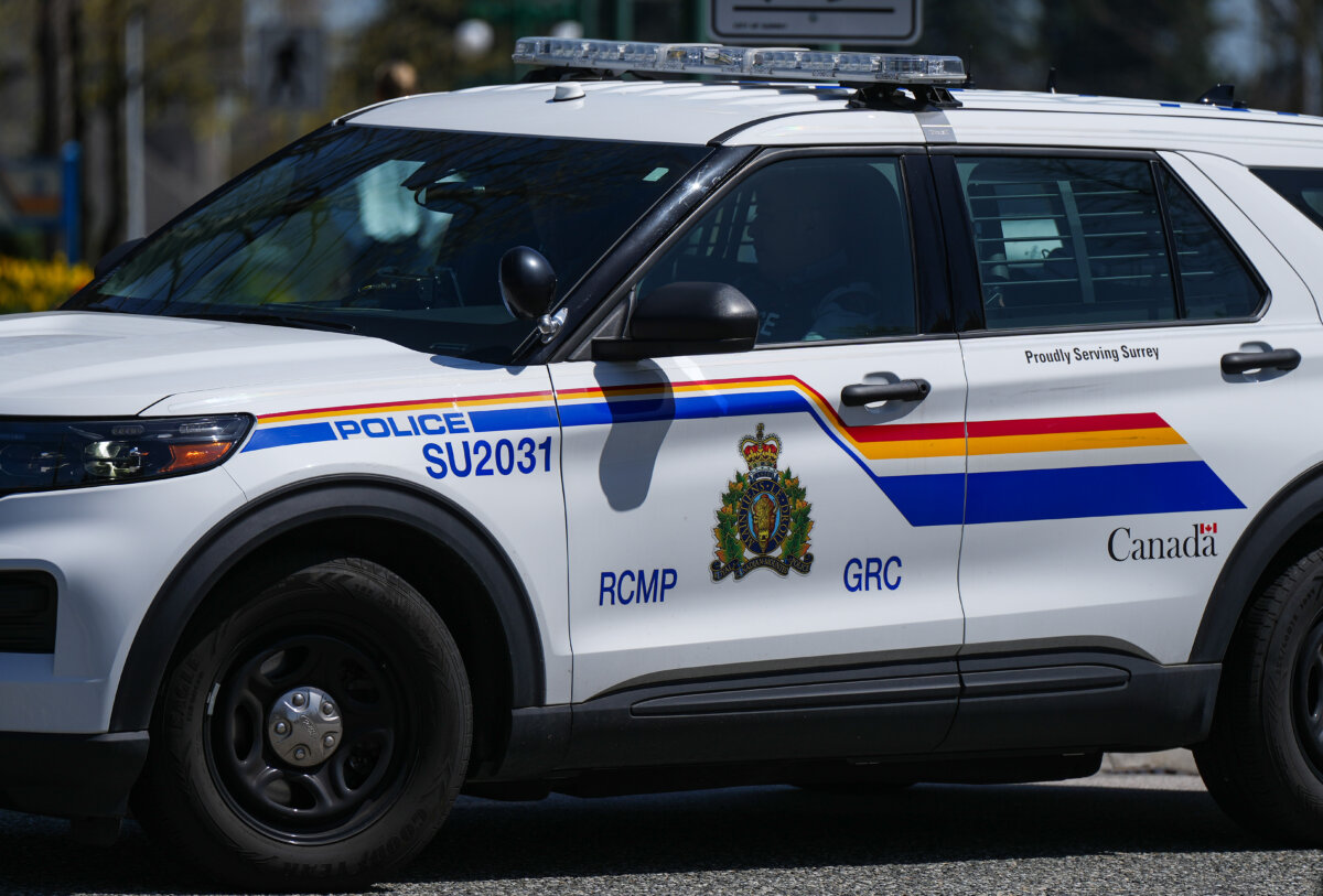 An RCMP officer drives a police vehicle in Surrey, B.C., on April 28, 2023. (The Canadian Press/Darryl Dyck)