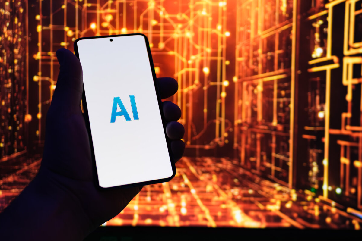 Photo illustration of a phone screen with AI logo. (Oleksii Pydsosonnii/The Epoch Times)