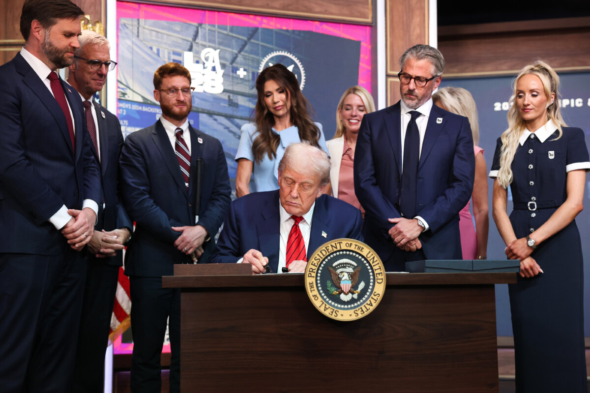 President Donald Trump signs an executive order during a ceremony in the South Court Auditorium in the Eisenhower Executive Office Building in Washington on Aug. 5, 2025. The executive order creates a White House task force to help coordinate logistical issues related to the 2028 Summer Olympic Games in Los Angeles including security, visas for athletes, and coaches and transportation. (Win McNamee/Getty Images)