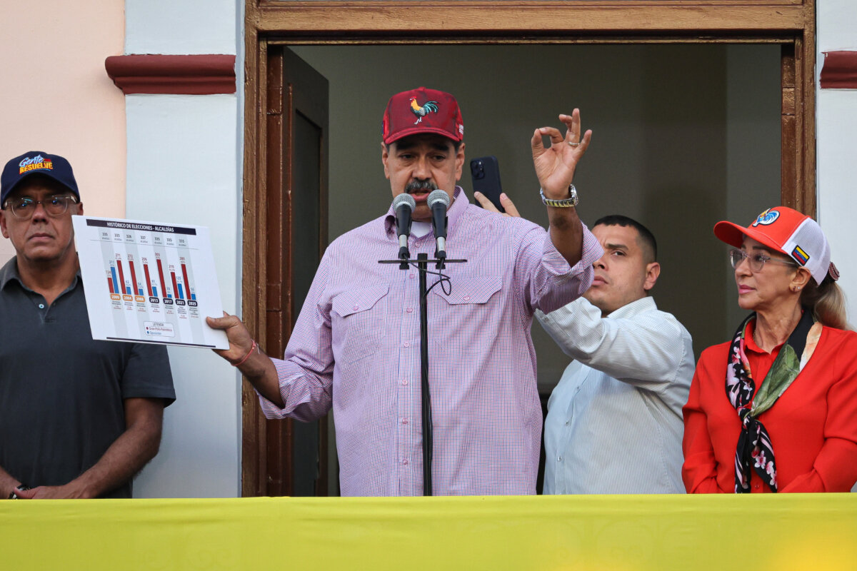Venezuelan leader Nicolás Maduro displays a chart with data alongside First Lady Cilia Flores and President of the National Assembly Jorge Rodríguez (L) at an event in Caracas, Venezuela, on July 28, 2025. (Jesus Vargas/Getty Images)