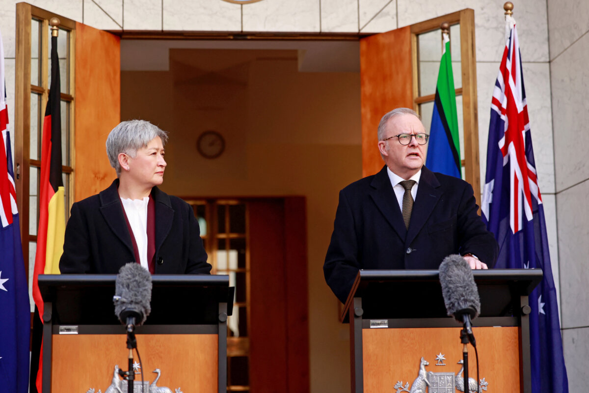 Australia's Foreign Minister Penny Wong (L) listens to Australia's Prime Minister Anthony Albanese as he speaks during a press conference in Canberra, Australia on Aug. 11, 2025. (Hilary Wardhaugh/AFP via Getty Images)