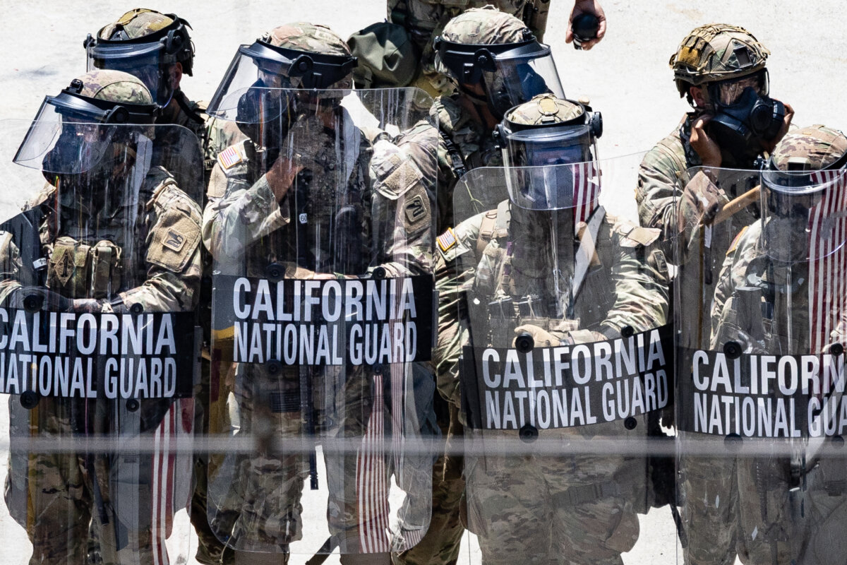 Immigration protesters confront federal agents and California Army National Guard members in Los Angeles, on June 8, 2025. (John Fredricks/The Epoch Times)