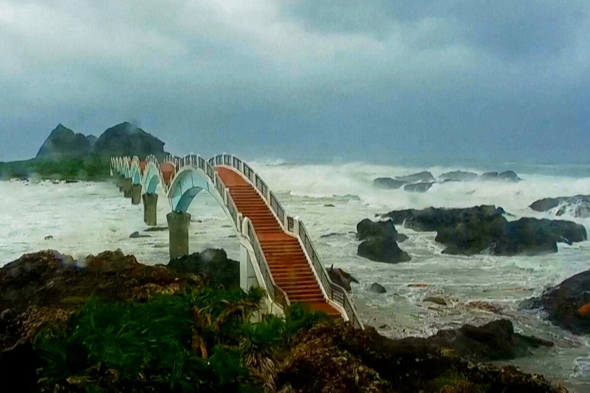 In this image made from video released by Taitung County Government, strong waves and heavy rain pound the Sansiiantai tourist spot on Aug. 13, 2025, as Typhoon Podul reaches Taitung, eastern Taiwan. (Taitung County Government via AP)