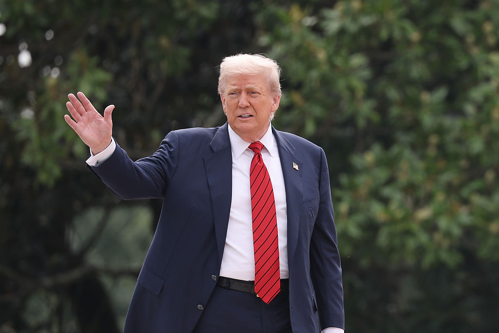 WASHINGTON, DC - AUGUST 05: U.S. President Donald Trump waves from the roof of the West Wing of the White House as he takes a tour on August 05, 2025 in Washington, DC. Trump has undertaken several renovation projects at the White House to include the construction of a concrete patio at the Rose Garden. (Photo by Win McNamee/Getty Images)