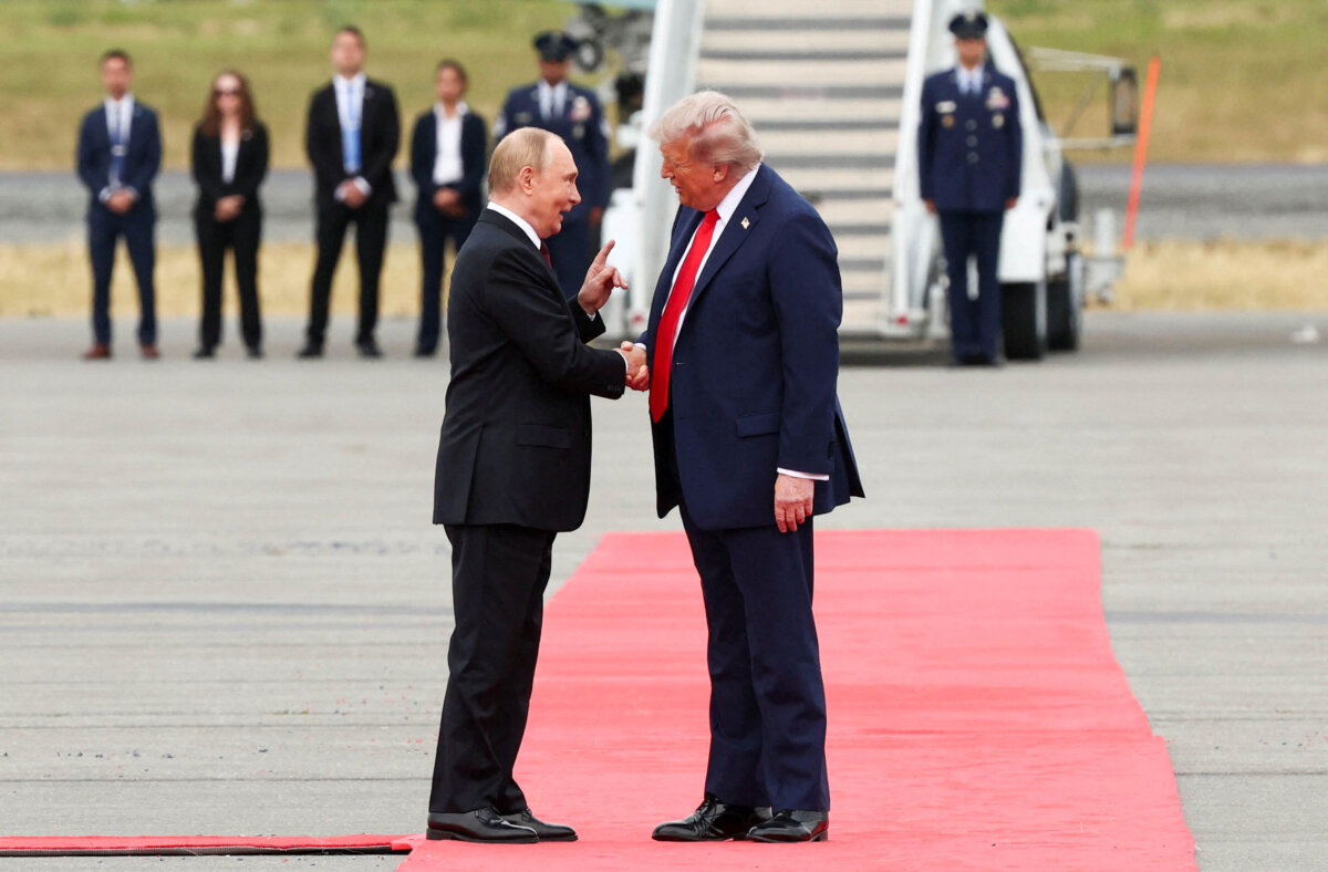 U.S. President Donald Trump shakes hand with Russian President Vladimir Putin, as they meet to negotiate for an end to the war in Ukraine, at Joint Base Elmendorf-Richardson in Anchorage, Alaska, on Aug. 15, 2025. (Reuters/Kevin Lamarque)