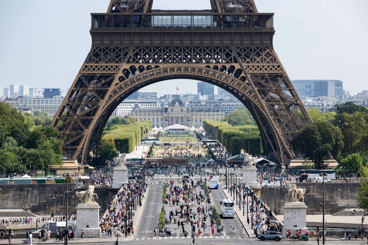 Tourists and pedestrians walk on the Iena Bridge near the Eiffel Tower in Paris on Aug. 16, 2025. (Martin Lelievre/AFP/Getty Images)