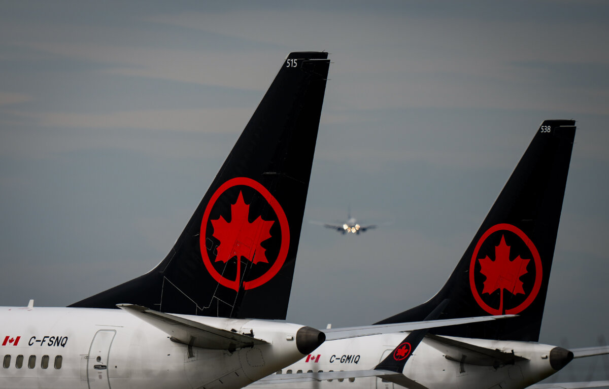 Air Canada Boeing 737 MAX 8 aircraft sit parked at Vancouver International Airport, in Richmond, B.C., on August 18, 2025. (The Canadian Press/Darryl Dyck)