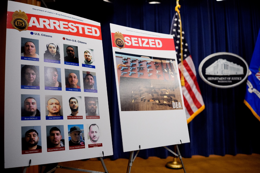 Posters with images of detained individuals and seized firearms are displayed at the Department of Justice in Washington on May 6, 2025. (Andrew Harnik/Getty Images)
