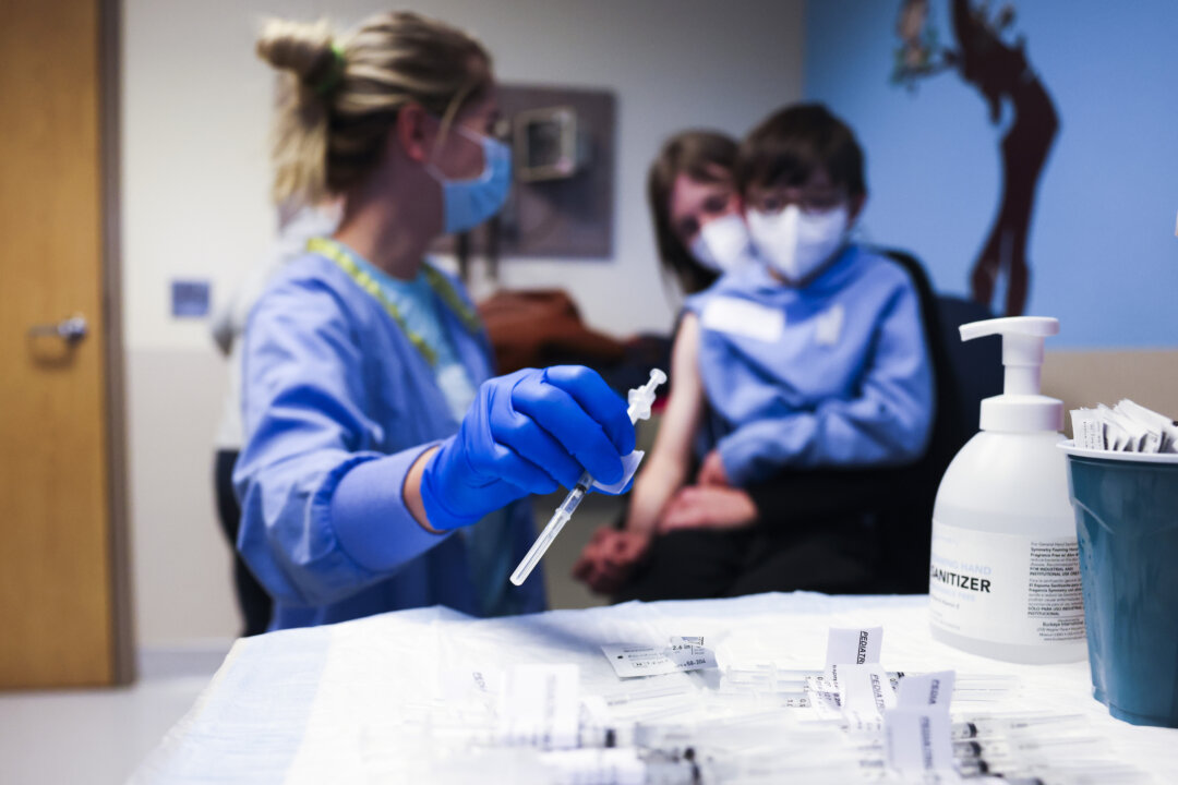 A nurse prepares to give a COVID-19 vaccine to a child in Denver, Colo., on Nov. 3, 2021. (Michael Ciaglo/Getty Images)
