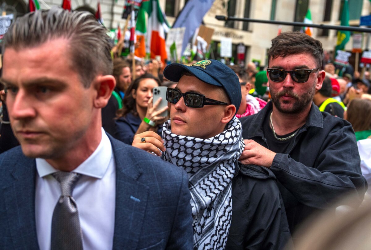 Kneecap band member Liam Óg Ó hAnnaidh, pictured wearing a keffiyeh, leaves Westminster Magistrates' Court on August 20, 2025, in London, England. Óg Ó hAnnaidh, was charged with a terror offence after allegedly displaying a flag in support of proscribed organization Hezbollah at a gig at the O2 Forum in Kentish Town in November 2024. (Carl Court/Getty Images)