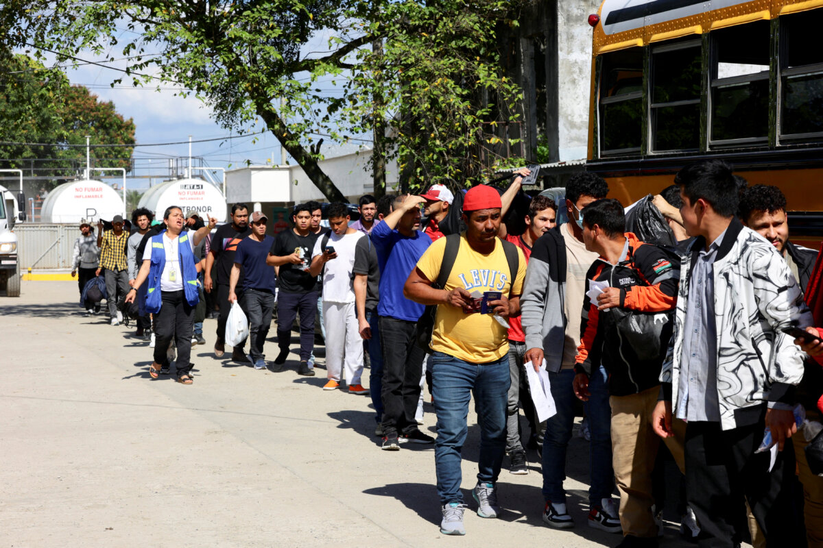 Honduran migrants deported from the United States wait in line to board a bus at the Center for Attention to Returned Migrants, in San Pedro Sula, Honduras, on Jan. 30, 2025. (Yoseph Amaya/Reuters)