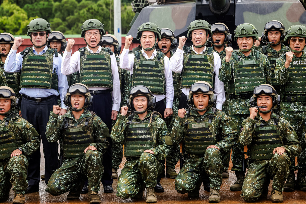 Taiwan’s Secretary-General of the National Security Council Joseph Wu (2nd L), President Lai Ching-te (C), and Minister of National Defense Wellington Koo (3rd R) pose with army officers in front of a U.S.-made Abrams tank in Hsinchu, Taiwan, on July 10, 2025. Taiwan’s defense ministry is tightening restrictions on access to military intelligence for service members with China ties amid concerns about CCP infiltration. (I-Hwa Cheng/AFP via Getty Images)