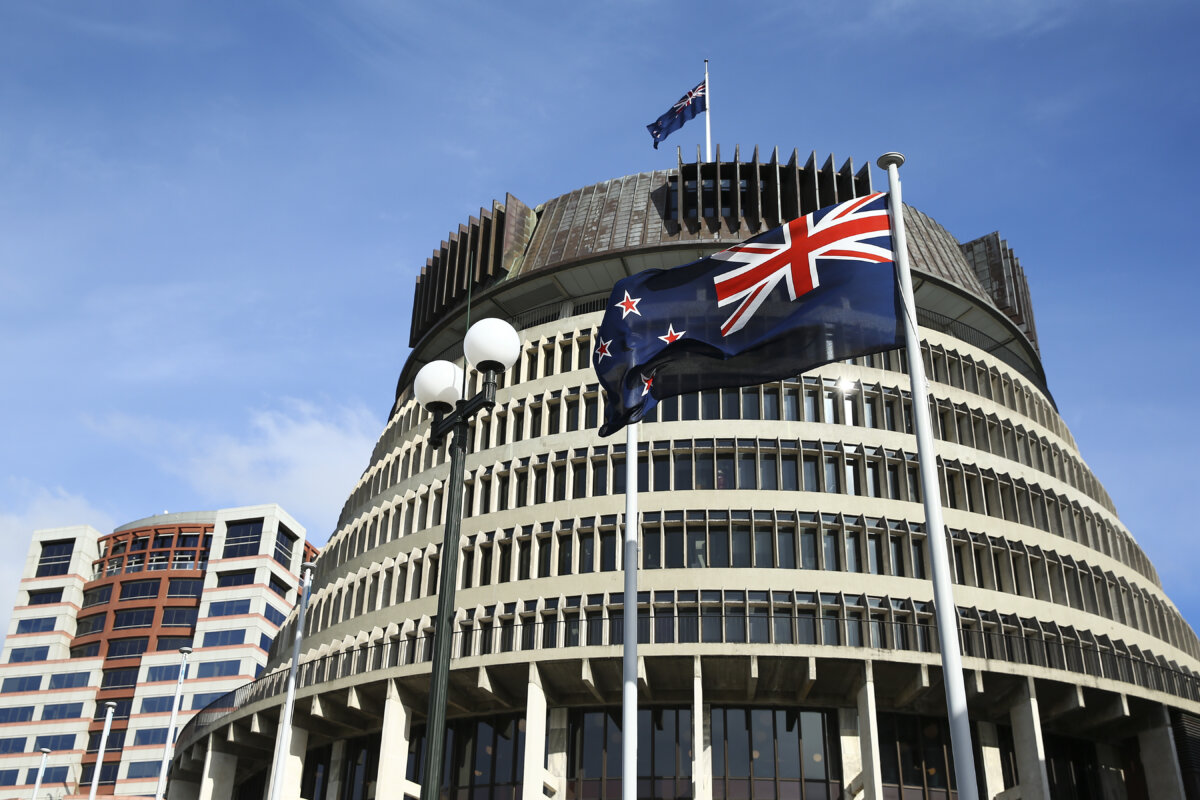 The New Zealand flag flies in front of The Beehive, the executive building within New Zealand's Parliament Buildings complex in Wellington on May 14, 2020. (Hagen Hopkins/Getty Images)