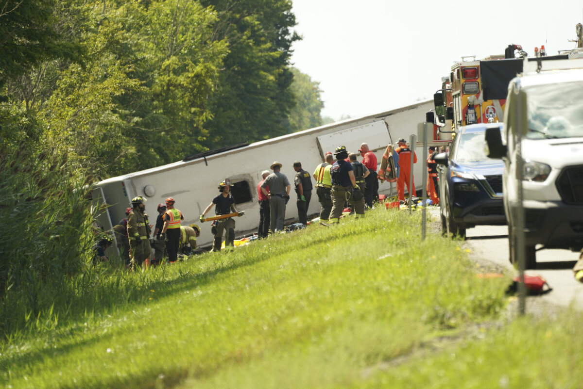 First responders work to rescue victims at the scene of a tour bus that crashed and rolled over on the New York State Thruway near Pembroke, N.Y., on Aug. 22, 2025. (Libby March/Buffalo News via AP)