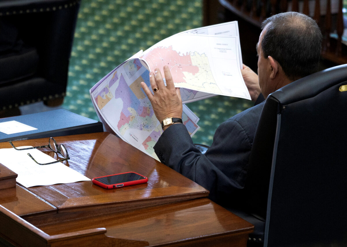 A state senator looks over redistricting maps as lawmakers consider a bill that would redraw the state's 38 congressional districts, at the Texas state Capitol in Austin, Texas, on Aug. 22, 2025. (Nuri Vallbona/Reuters)