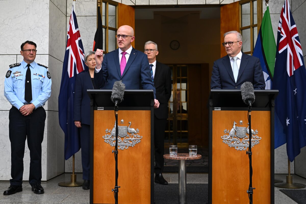 Australian Prime Minister Anthony Albanese (R) and Director-General of ASIO Mike Burgess speak to the media during a press conference at Parliament House in Canberra, Australia on Aug. 26, 2025. Behind them stand Reece Kershaw (L), commissioner of the Australian Federal Police, Foreign Minister Penny Wong, and Home Affairs Minister Tony Burke. (AAP Image/Lukas Coch)