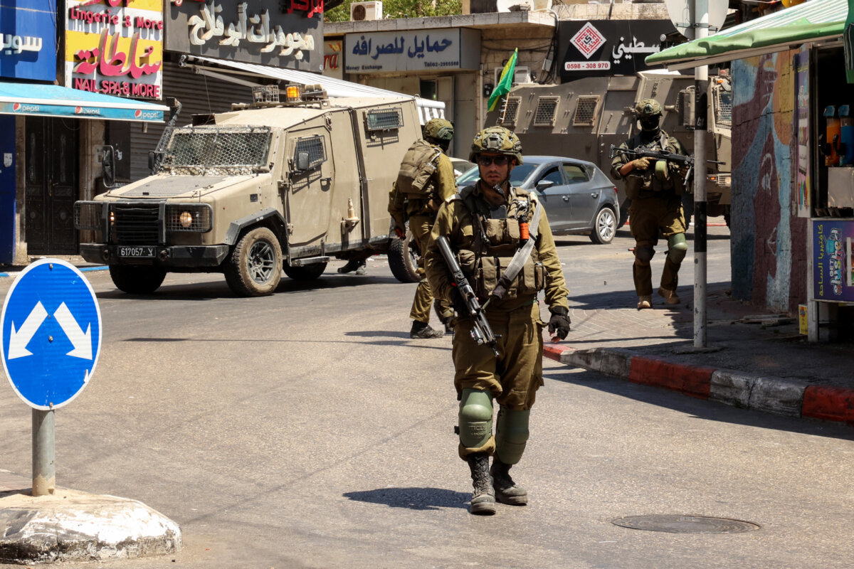 Israeli soldiers conduct a raid in Ramallah city in the occupied West Bank on Aug. 26, 2025. (Zain Jaafar/AFP via Getty Images)