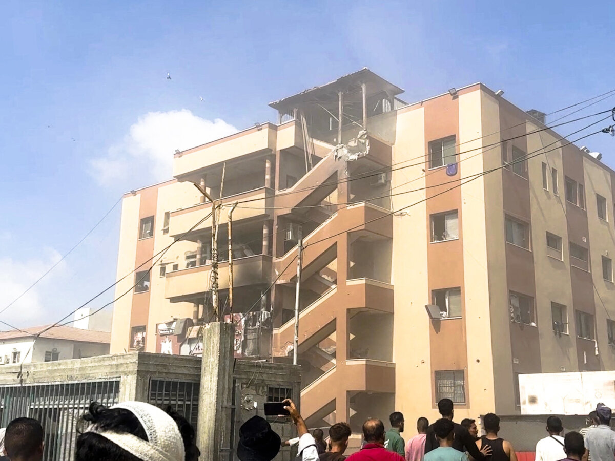 People walk at the site of Israeli strikes on Nasser Hospital, in which several journalists and others were killed, in Khan Younis, Gaza Strip, in this image taken from video on Aug. 25, 2025. REUTERS/Hatem Khaled