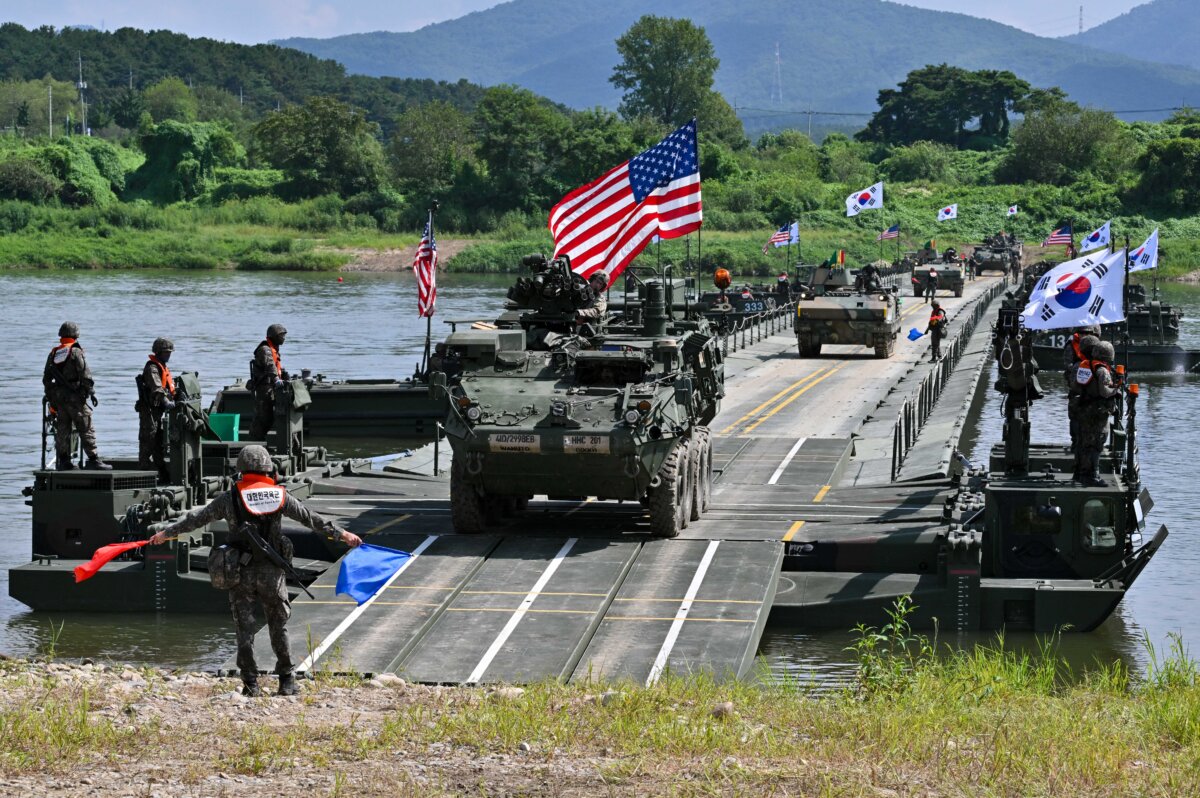 A U.S. Stryker infantry carrier vehicle (C) crosses a river over a floating bridge during a South Korea-U.S. joint drill as part of the annual Ulchi Freedom Shield exercise in Yeoju, South Korea, on Aug. 27, 2025. (Jung Yeon-je/AFP via Getty Images)