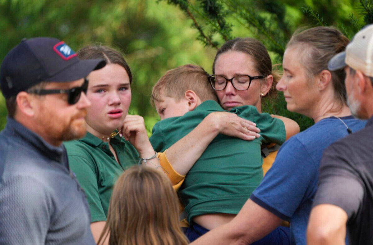 Parents comfort their children after a shooting at Annunciation Church in Minneapolis on Aug. 27, 2025. (Alex Kormann/Star Tribune via AP)