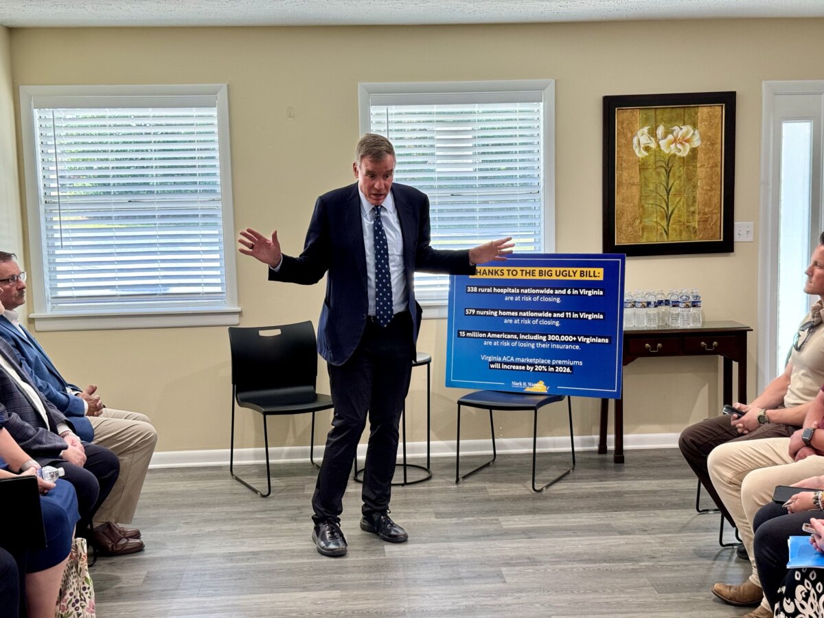U.S. Senator Mark Warner (D-Va.) speaks to a group of health care industry experts during an event at Appomattox, Va., on Aug. 27, 2025 (Arjun Singh/The Epoch Times)