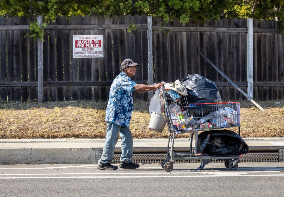 A man gathers recyclables in Los Angeles on July 15, 2025. (John Fredricks/The Epoch Times)