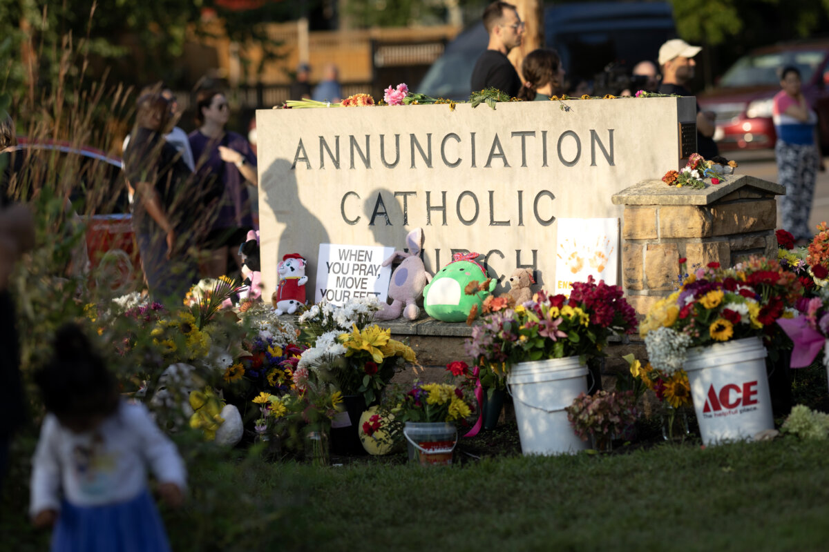 People leave flowers and other mementos in front of Annunciation Catholic Church, a rapidly growing memorial to the victims of a shooting, in Minneapolis on Aug. 28, 2025. (Scott Olson/Getty Images)