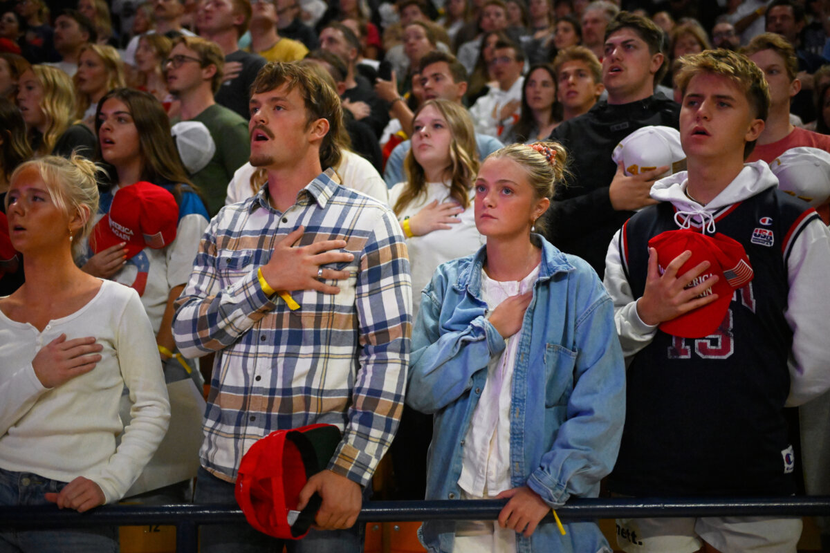 People stand for the national anthem during a Turning Point USA rally at Utah State University, as a part of the organization's push to memorialize Charlie Kirk, in Logan, Utah, on Sept. 30, 2025. (Alex Goodlett/AP Photo)