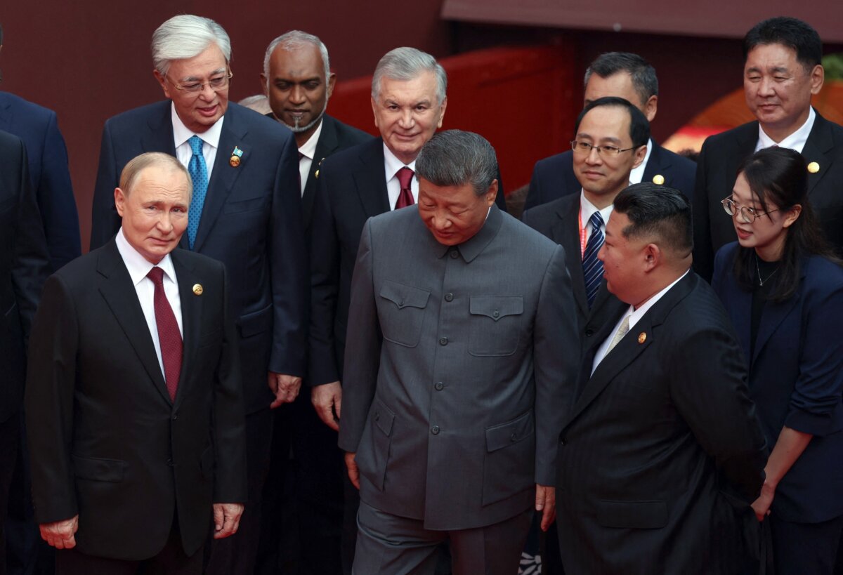 Russian President Vladimir Putin (L) speaks with Chinese leader Xi Jinping (C) and North Korea's Kim Jong Un (R) after a group photograph before a military parade to marking the 80th anniversary of the end of World War II, on Tiananmen Square in Beijing on Sept. 3, 2025. (Alexander Kazakov/Pool/AFP via Getty Images)