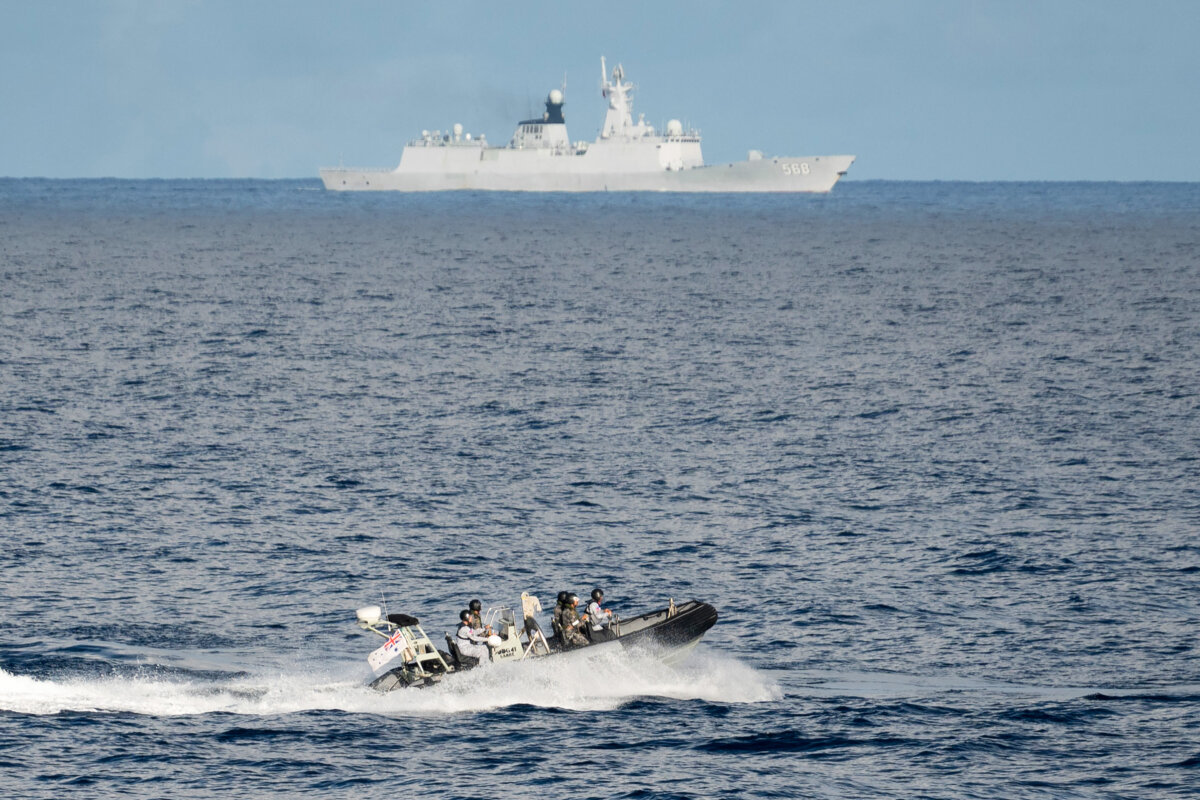 A Chinese PLA Navy ship (back) is seen past Royal Australian Navy sailors aboard their inflatable rigid hull boat during a maritime cooperative activity between the Philippines, Australia and Canadian navies near Scarborough Shoal in disputed waters of the South China Sea on Sept. 3, 2025. (Ted Aljibe/AFP via Getty Images)