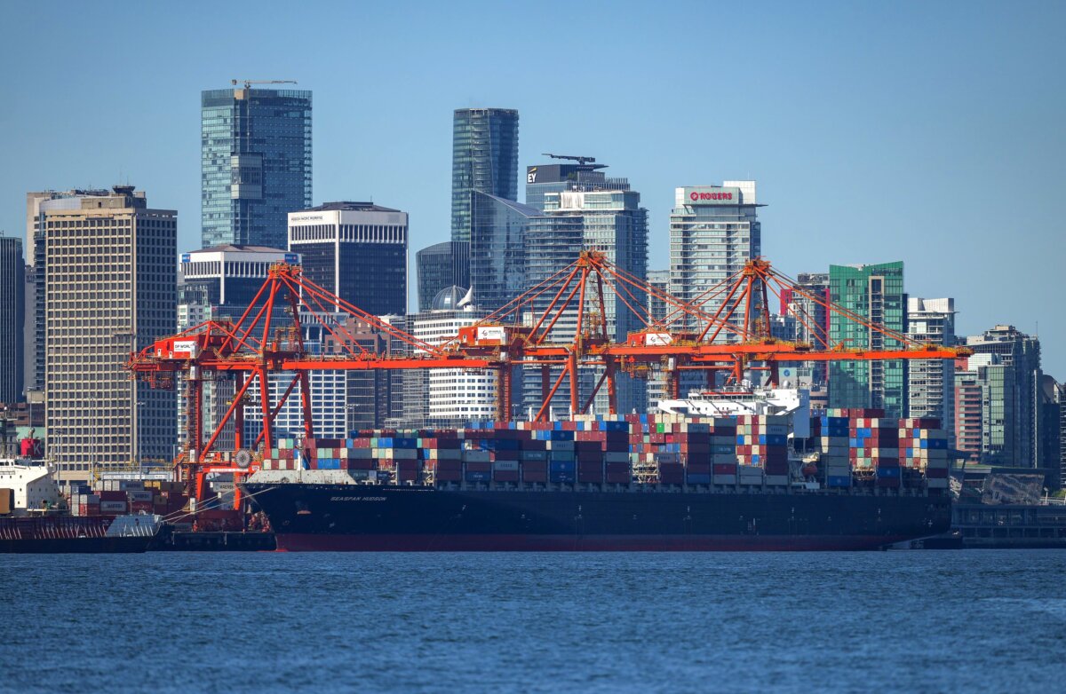 A container ship docked under gantry cranes at a port in Vancouver in a file photo. (The Canadian Press/Darryl Dyck)