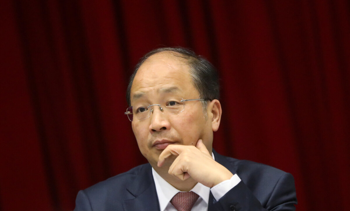 Yi Huiman, chairman of China Securities Regulatory Commission, attends a meeting of Fujian delegation on the sidelines of the National People's Congress in Beijing on March 5, 2019. (Stringer/Reuters)