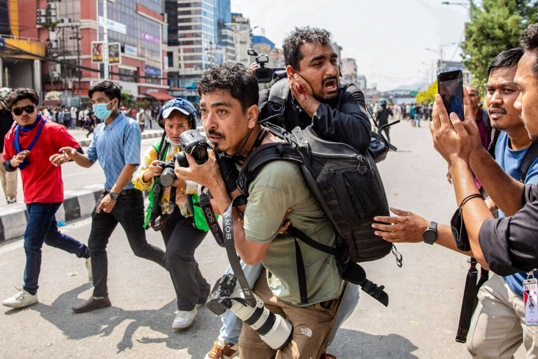 NextImg:Day in Photos: Protests in Nepal, Shooting in Jerusalem, and Total Lunar Eclipse
