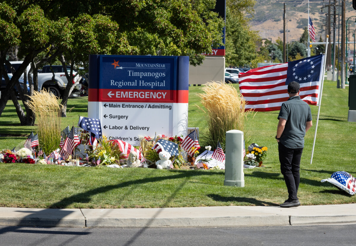 People lay flowers and items in memory of Charlie Kirk at Timpanogos Regional Hospital, in Orem, Utah, on Sept. 11, 2025. (John Fredricks/The Epoch Times)
