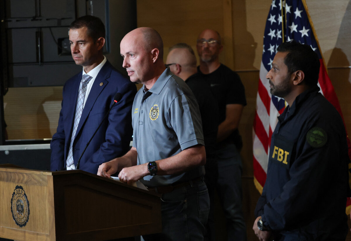 (L-R) Utah Department of Public Safety Beau Mason, Utah Gov. Spencer Cox, and FBI Director Kash Patel attend a press conference outside the Doterra Auditorium at Utah Valley University during a public event in Orem, Utah, on Sept. 11, 2025, a day after political activist and influencer Charlie Kirk was shot. (Patrick T. Fallon/AFP via Getty Images)