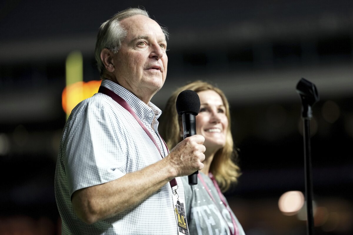 Texas A&M University President Mark A. Welsh addresses the crowd inside Kyle Field as his wife Betty looks on during Midnight Yell in College Station, Texas, on Aug. 30, 2025. (Sam Craft/AP Photo)