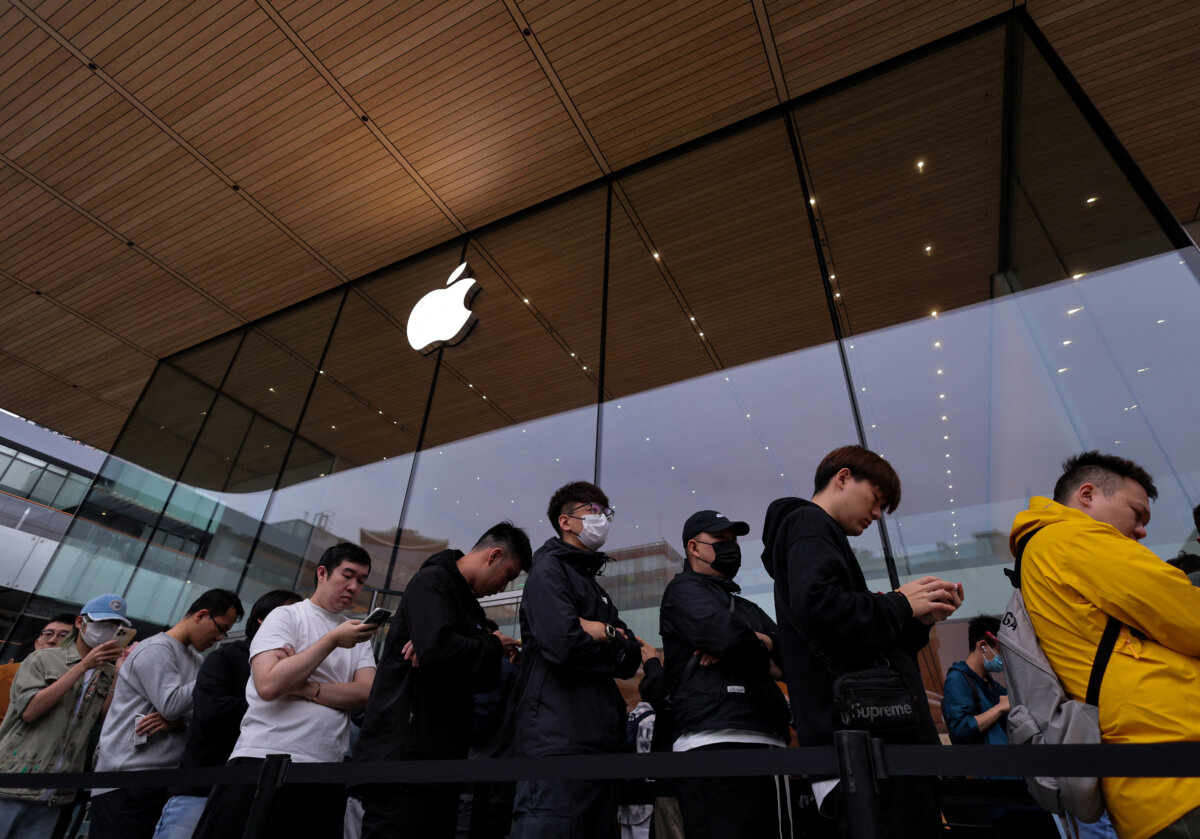 People line up outside of an Apple store as the new iPhone 17 series smartphones go on sale, in the Sanlitun area of Beijing on Sept. 19, 2025. (Reuters/Maxim Shemetov)