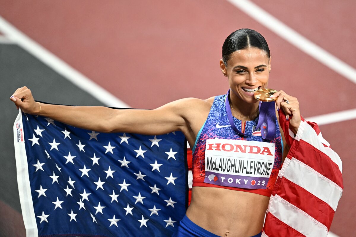 Sydney McLaughlin-Levrone celebrates with her country's flag and her medal after winning in the women's 400m final during the World Athletics Championships in Tokyo on Sept. 18, 2025. (Philip Fong/AFP via Getty Images)