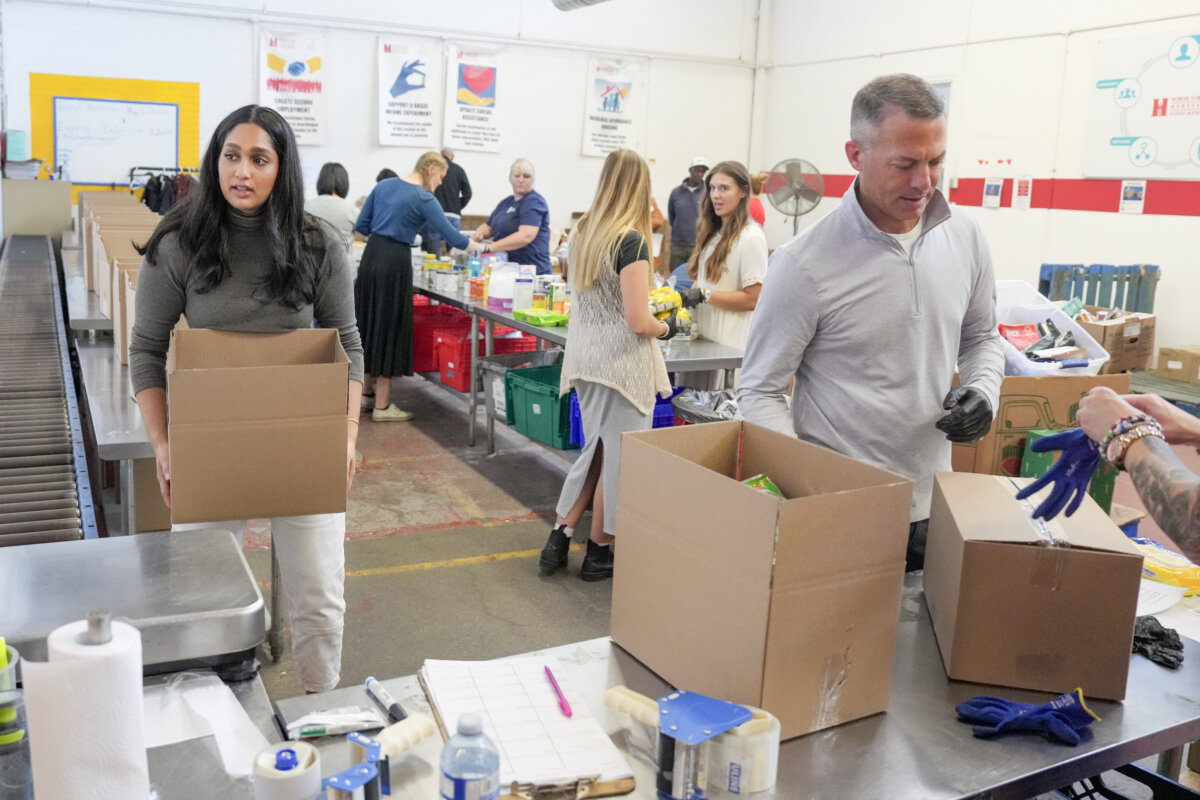 Volunteers work at a Food Banks Canada distribution center in Toronto on Oct. 24, 2024. (The Canadian Press/Chris Young)