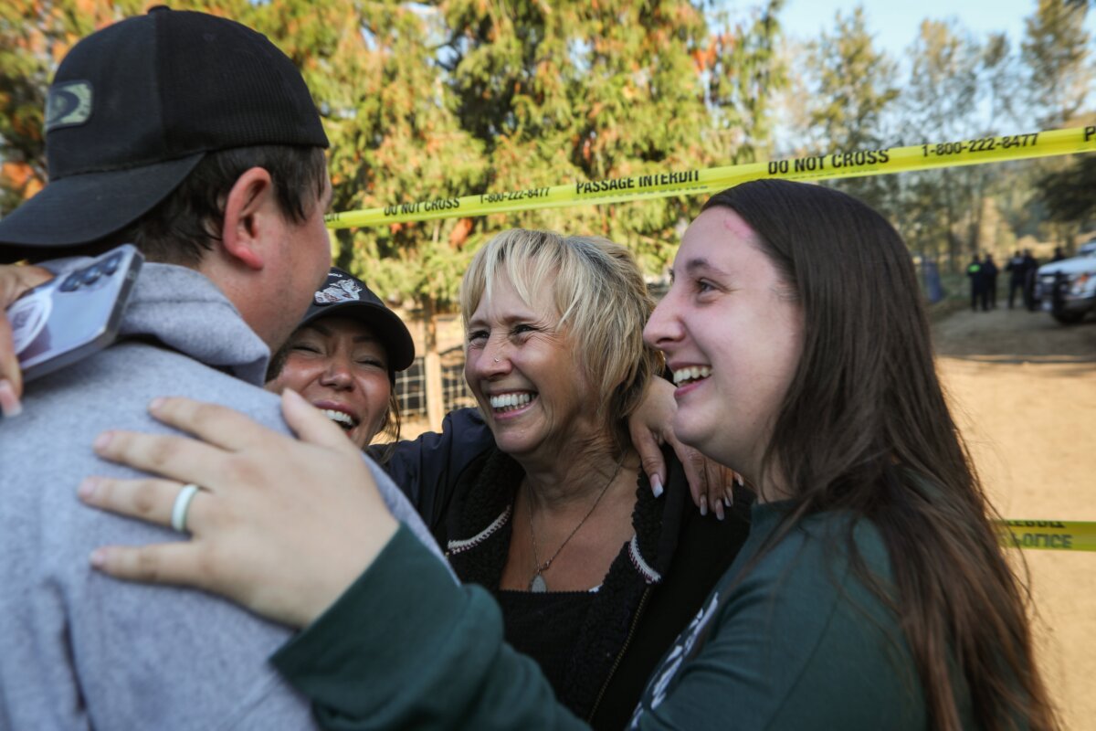 Karen Espersen, co-owner of Universal Ostrich Farms in Edgewood, B.C., celebrates with her family after learning that the Supreme Court of Canada granted an interim stay order on Sept. 24, 2025, delaying the culling of the farm’s entire herd of some 400 ostriches. (The Canadian Press/Aaron Hemens)