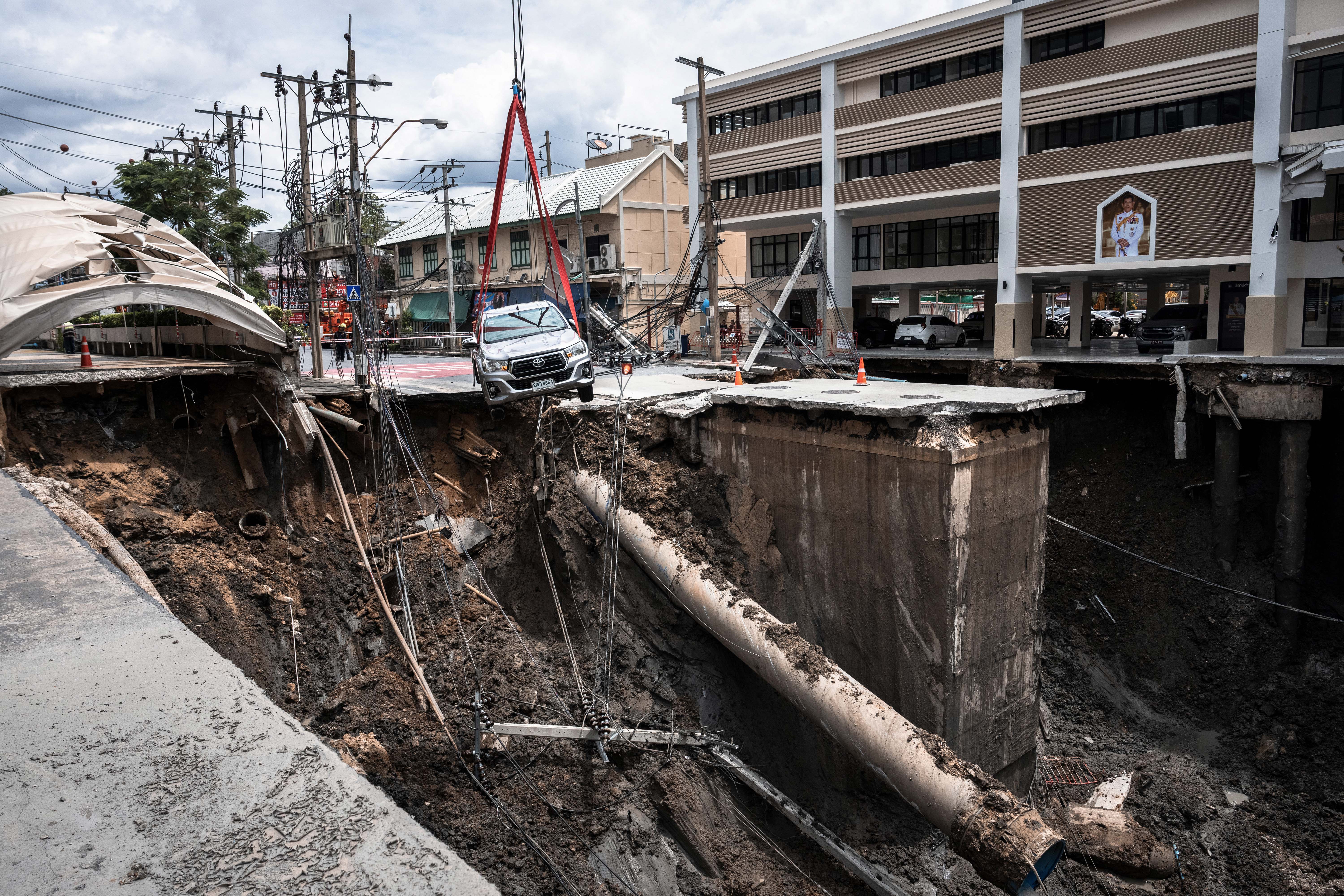 Day in Photos: Road Collapse In Bangkok, Shooting at an ICE Office, and Mine Accident