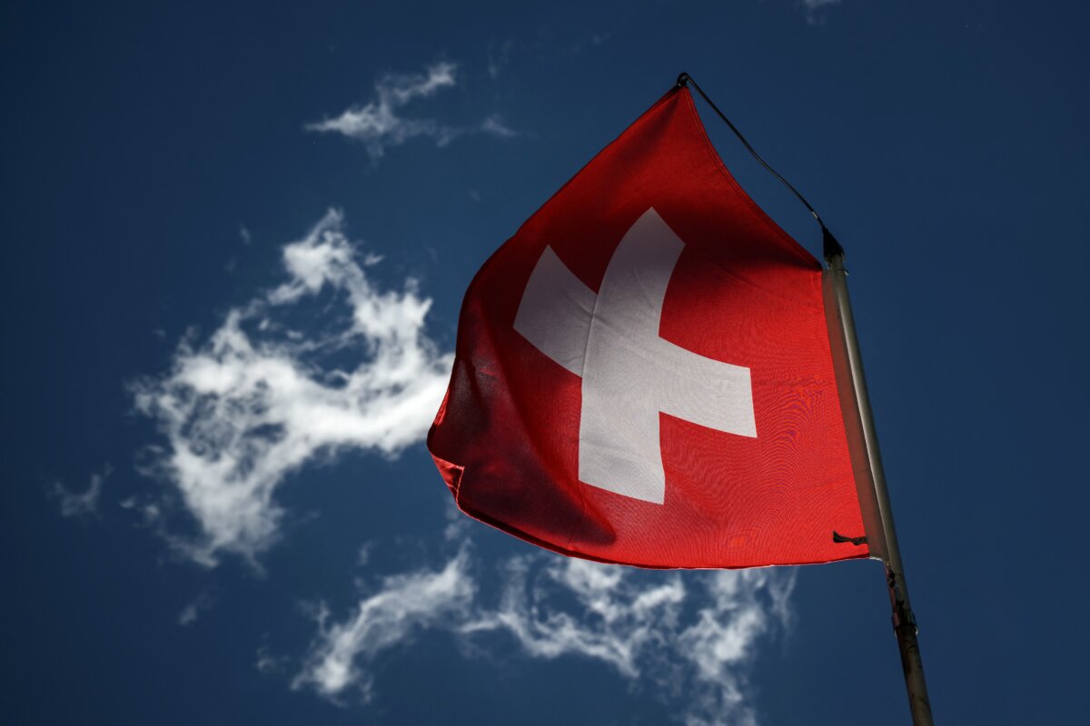 A Swiss national flag flutters in a blue sky in Bourg-Saint-Pierre, western Switzerland, on June 21, 2022. (Fabrice Coffrini/AFP via Getty Images)