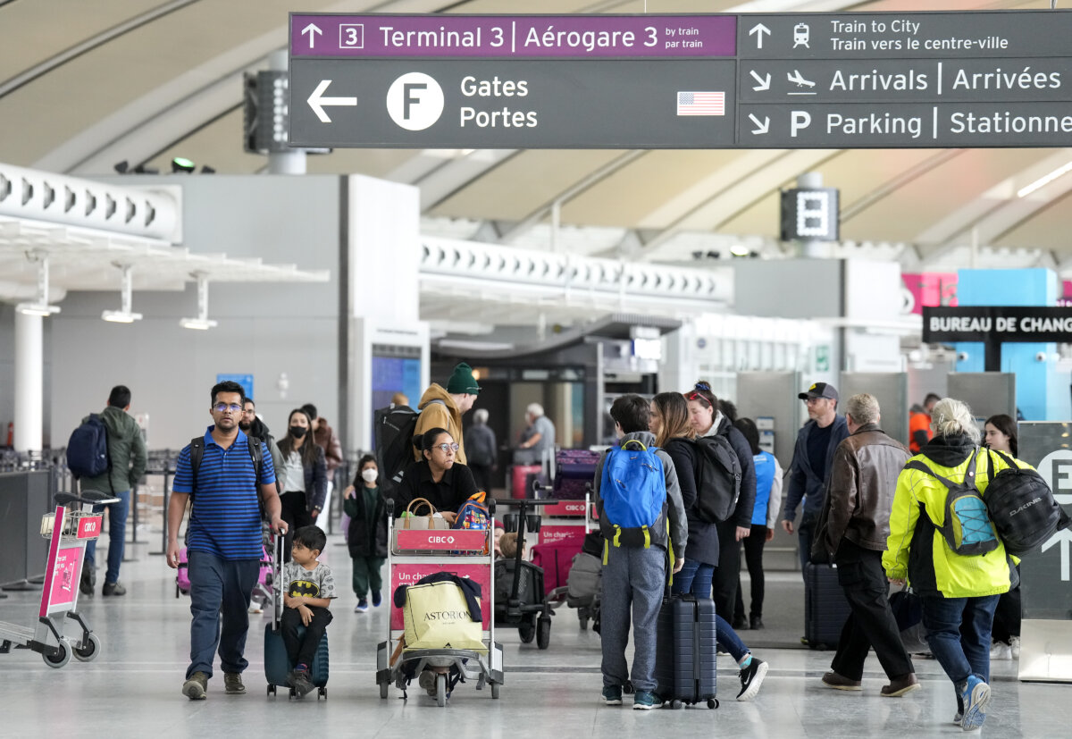 People walk through Pearson International Airport in Toronto on March 10, 2023. (The Canadian Press/Nathan Denette)