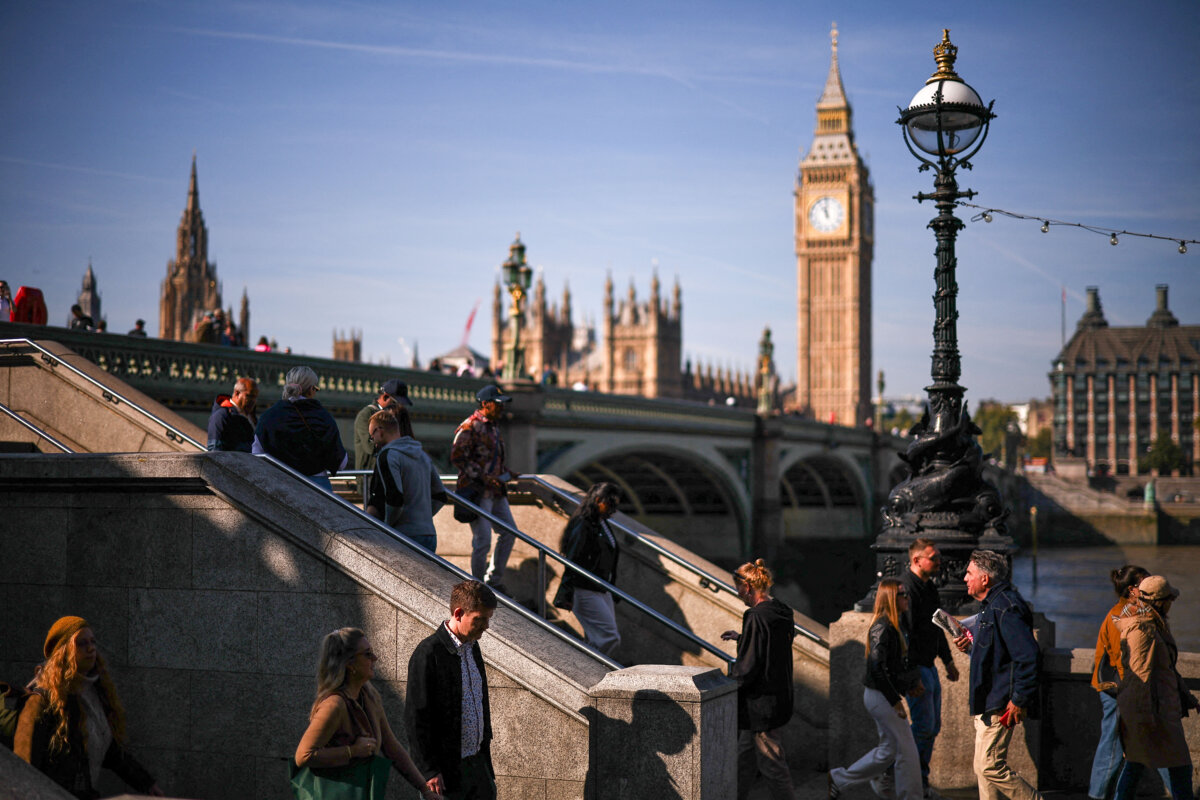 Pedestrians walk along the South Bank, with the Elizabeth Tower and the Houses of Parliament in the background, in London on Sept. 29, 2025. (Henry Nicholls/AFP via Getty Images)