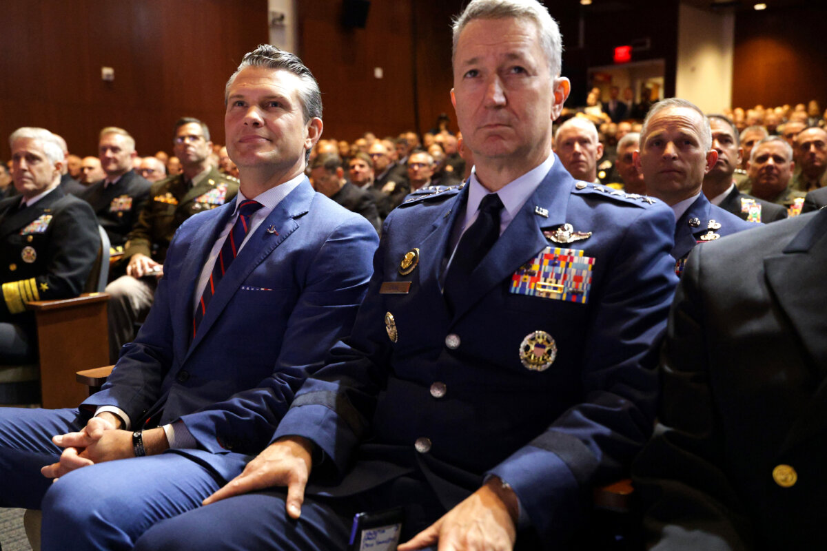 Secretary of War Pete Hegseth (L) and Chairman of the Joint Chiefs of Staff Air Force Gen. Dan Caine listen as President Donald Trump speaks to senior military members at Marine Corps Base Quantico, in Quantico, Va., on Sept. 30, 2025. (Alex Wong/Getty Images)