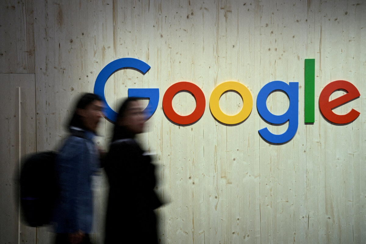 People walk next to a Google logo during a trade fair in Hanover, Germany, on April 22, 2024. (Reuters/Annegret Hilse/File Photo)