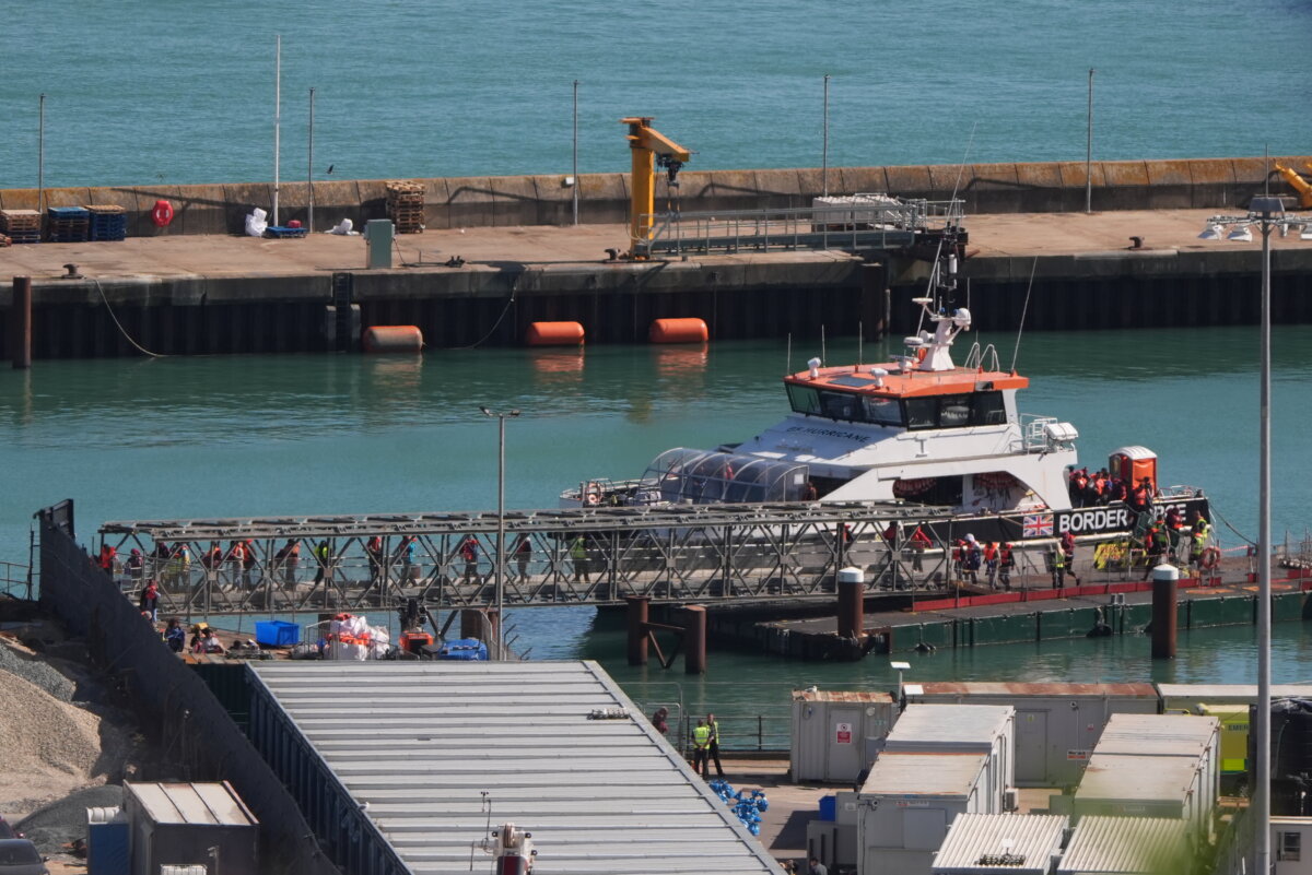 A group of people thought to be migrants are brought in to the Border Force compound in Dover, Kent, from a Border Force vessel. (Gareth Fuller/PA)
